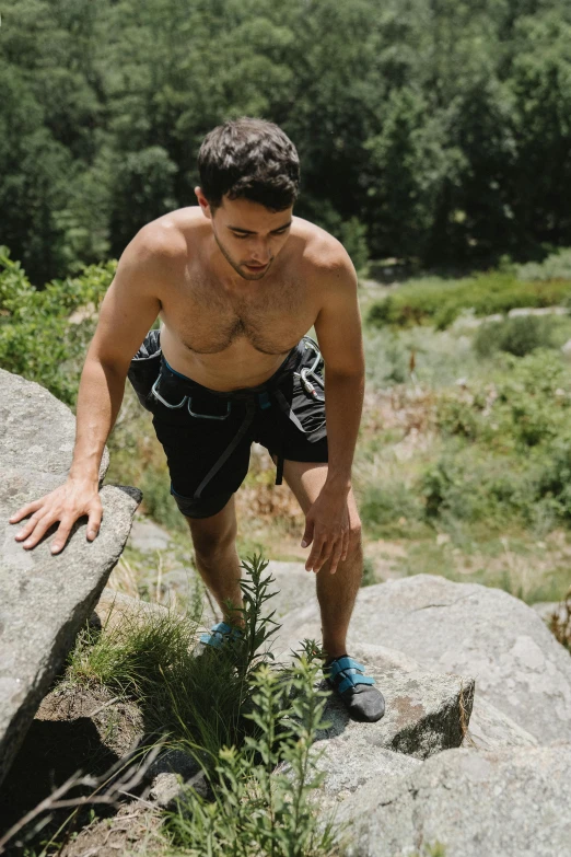 a man climbing up the side of a rock