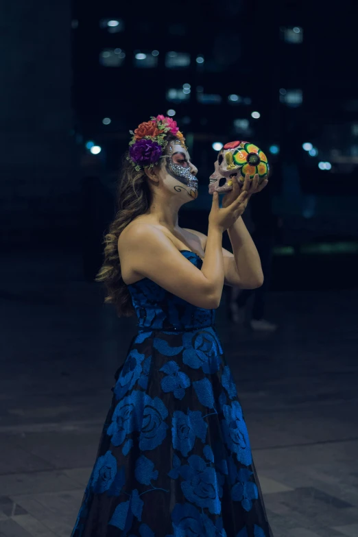 a woman holding an item while wearing a mask