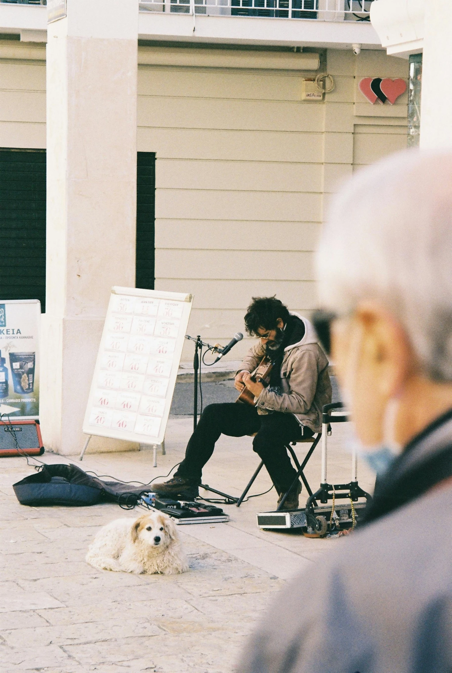 a person is playing music in front of an elderly woman