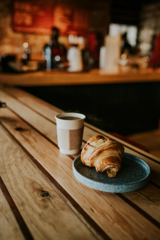 a tray of food and a cup on a table