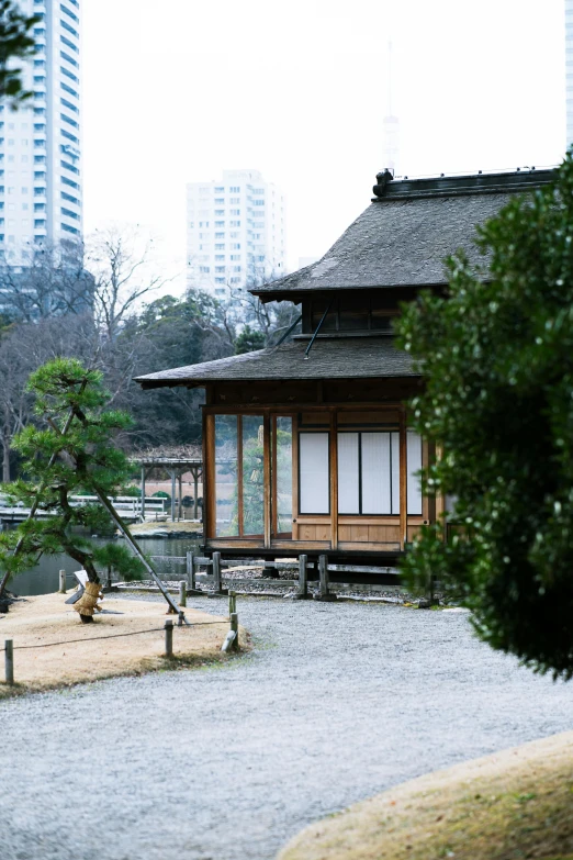 a house is surrounded by tall buildings in an asian style setting