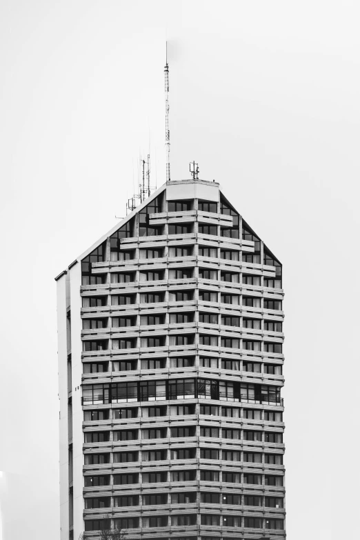 a very tall building next to a large tall building