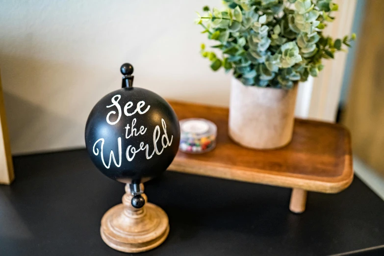 there is a black globe on a small table