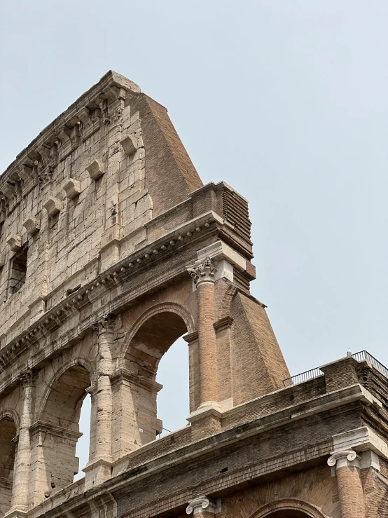 an old roman structure with two arches and clock on top