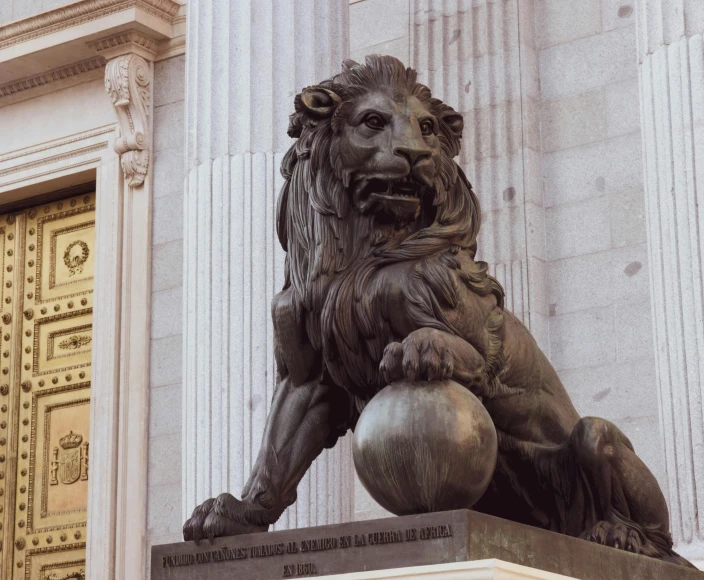 the large lion is sitting by the doorway