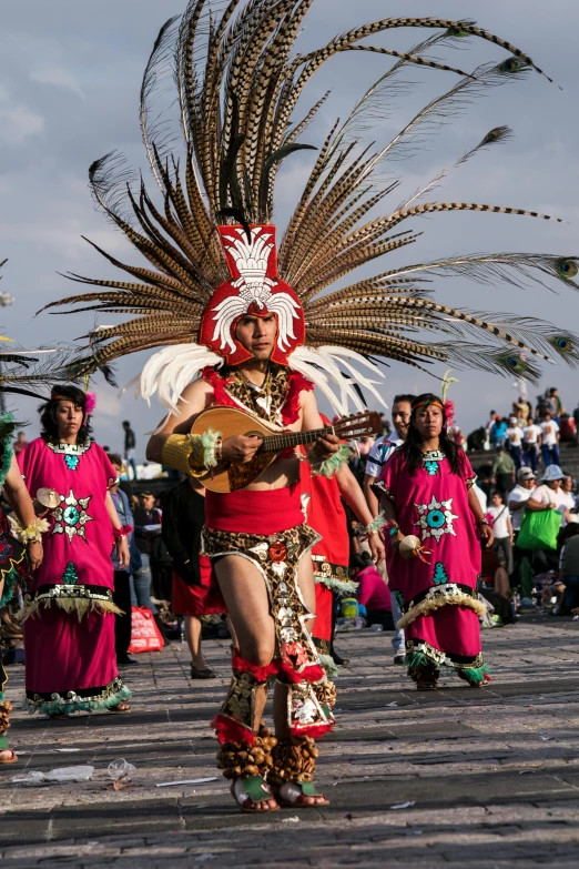 a woman wearing a headdress and costume in a parade