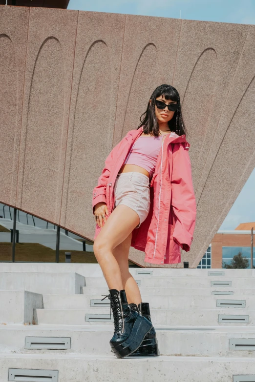 the girl is standing on some concrete steps