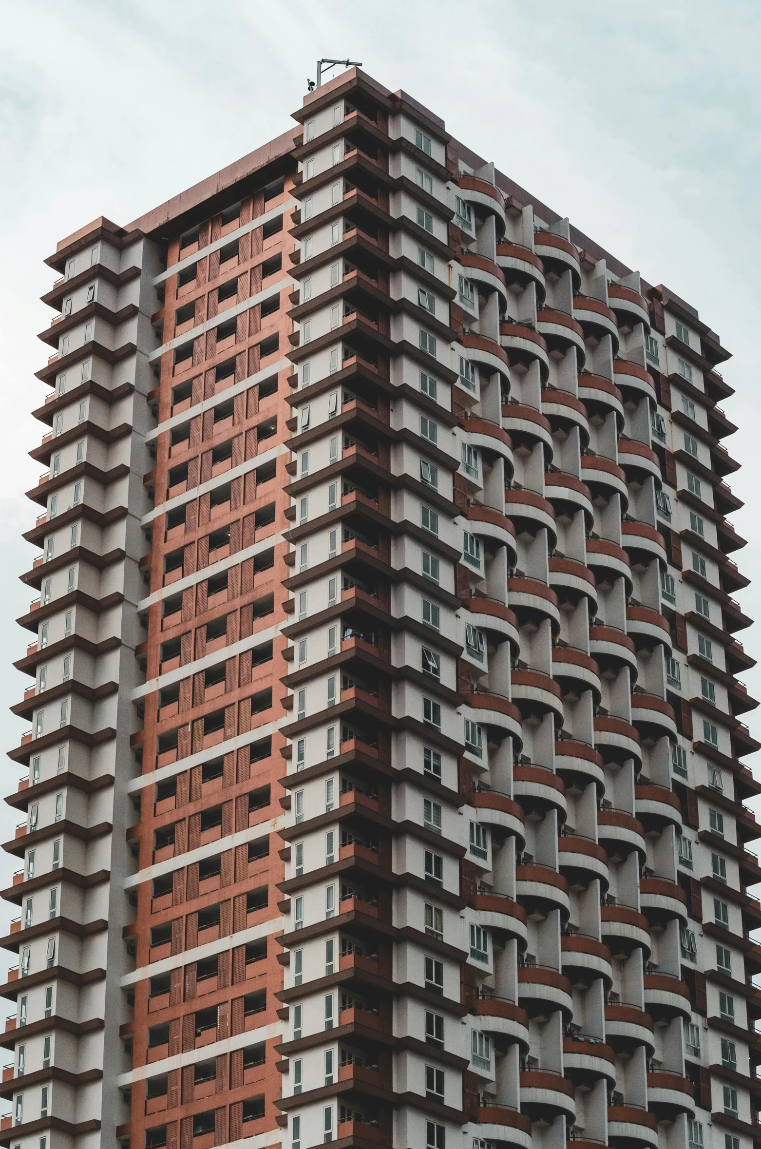 a large high rise building next to a cloudy sky