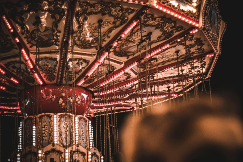 a close up of a merry go round at night