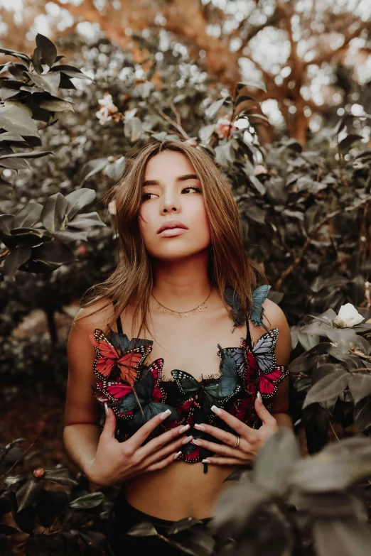 a woman with  and flowers is surrounded by leaves