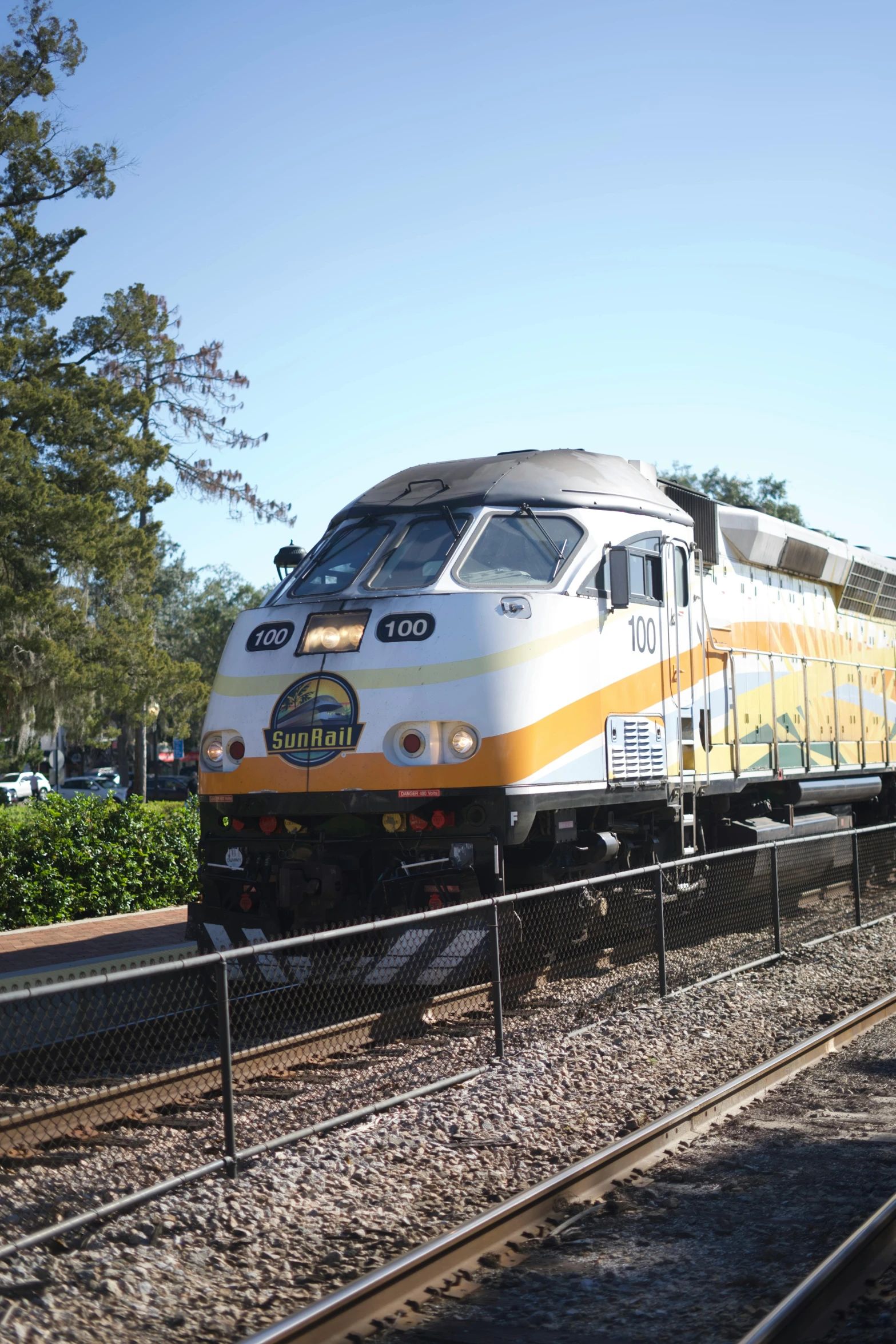 a train is going by the platform on the tracks