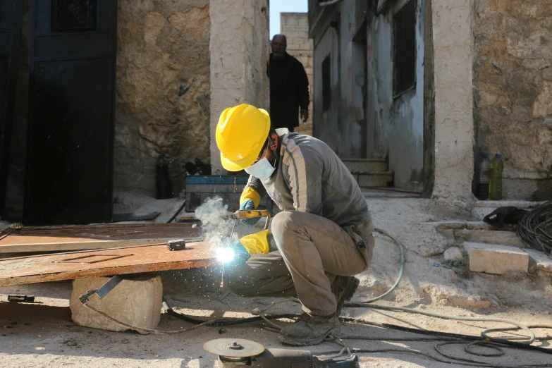 a man welding on a piece of wood