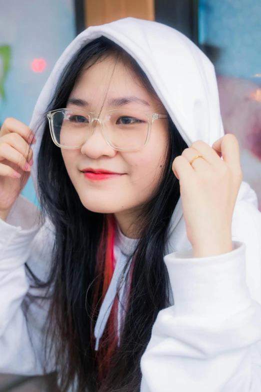 a woman with glasses standing and looking around