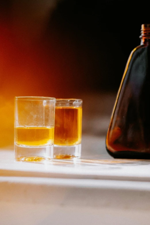 a pair of glasses sit next to an empty glass