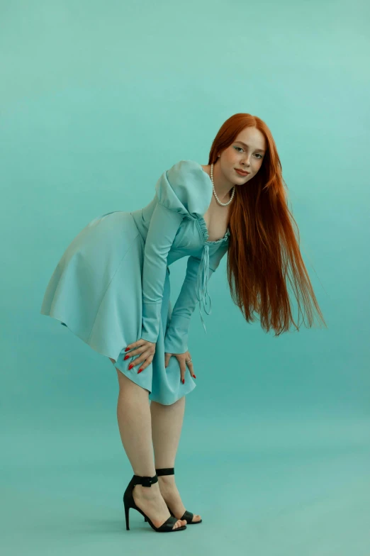 a woman is posing with her long red hair