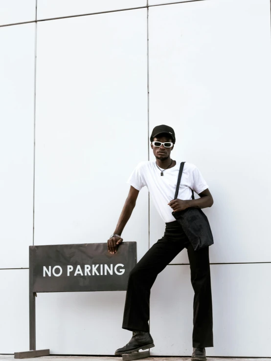 a man standing on top of a parking sign