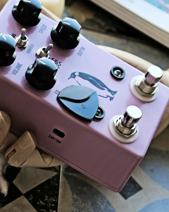 the top end of the pink and black guitar pedalbox