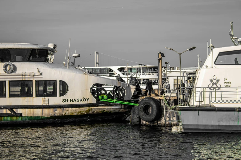 an old ferry boat is docked next to a tugboat