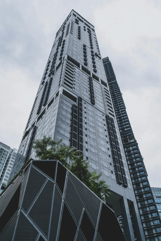 a tall building is shown against the cloudy sky