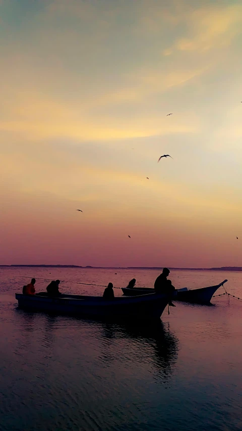 several men are riding on top of a boat in the water