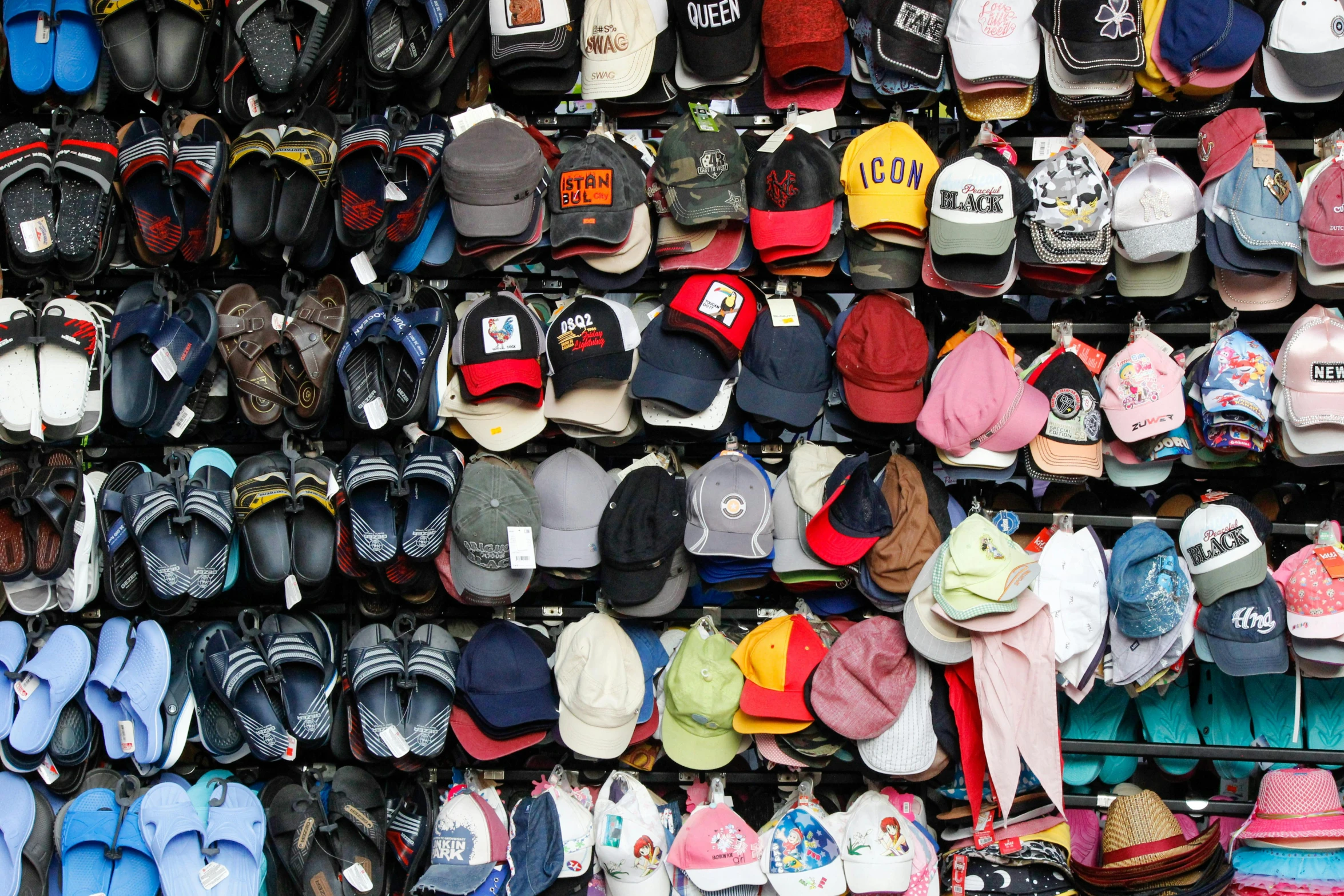 a huge number of hats hanging on a wall