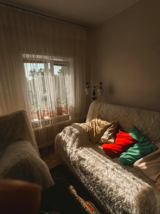 there is a sofa sitting in the corner near a window