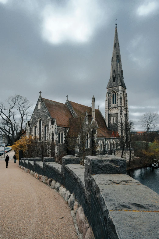 an old church next to a brick paved path