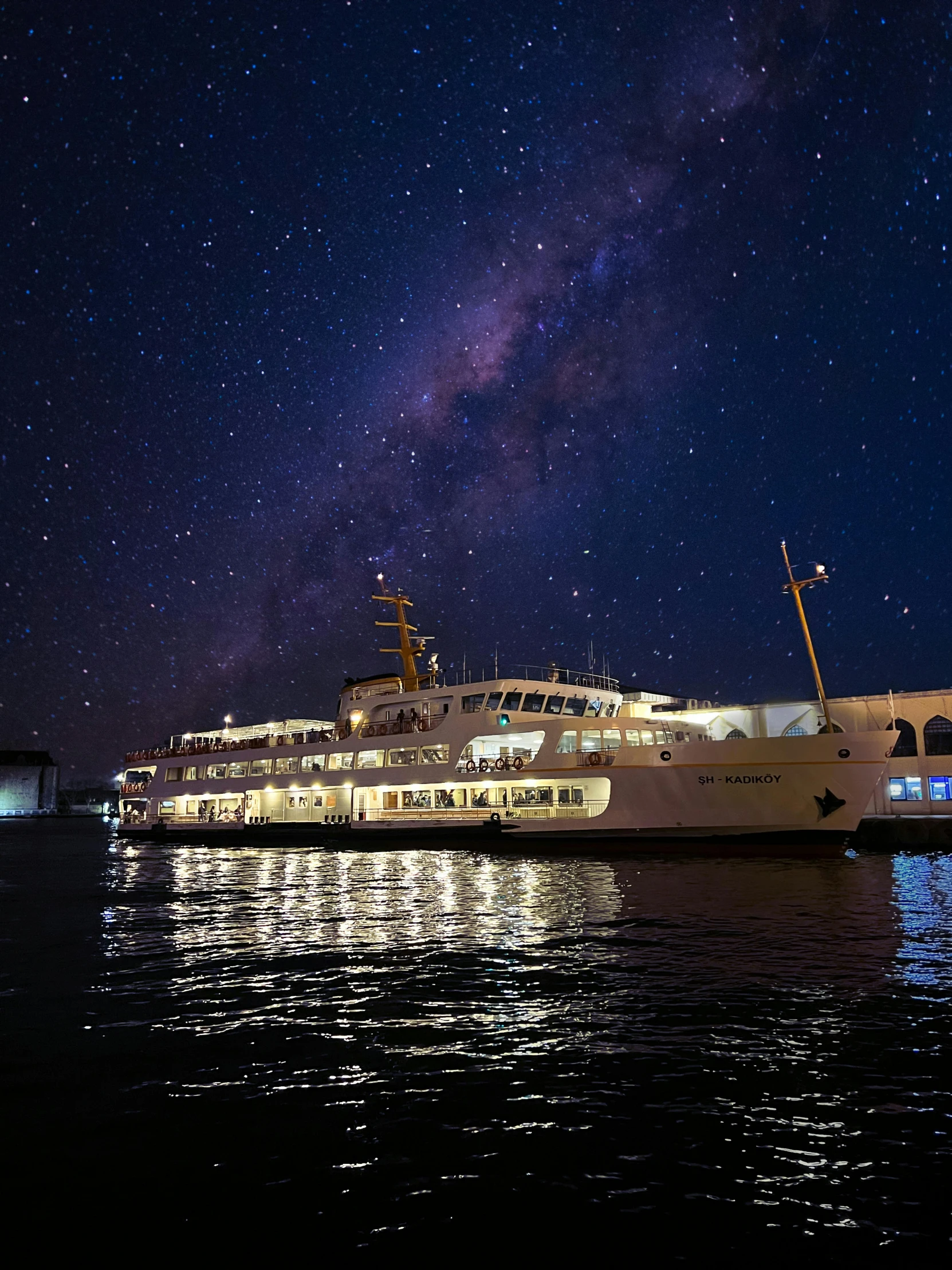 a big white ship sitting at night under the stars