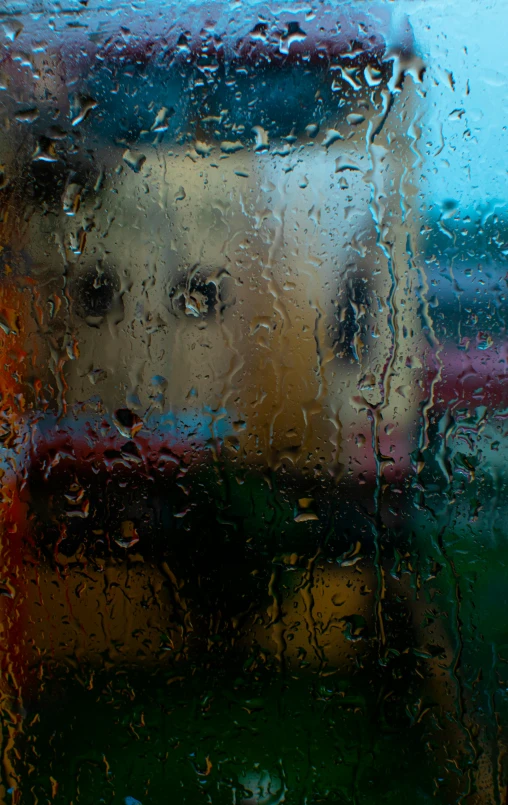 a colorful image of a person behind a window on a rainy day