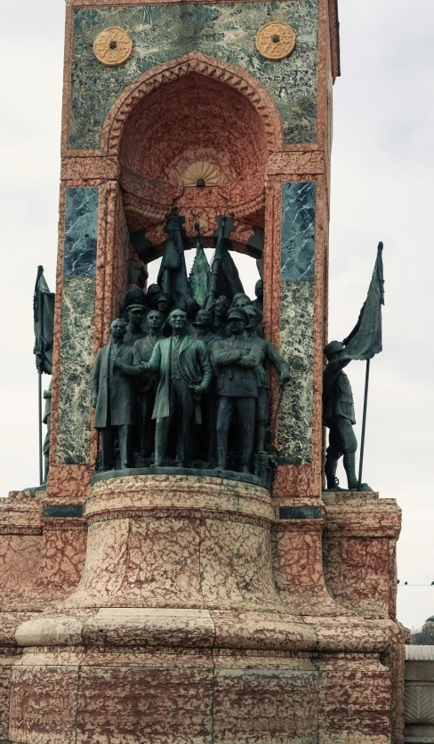 statue on top of brick structure in large open area