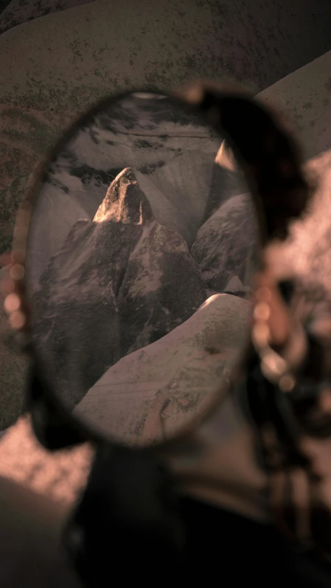 a picture of the view through a mirror of some rocks