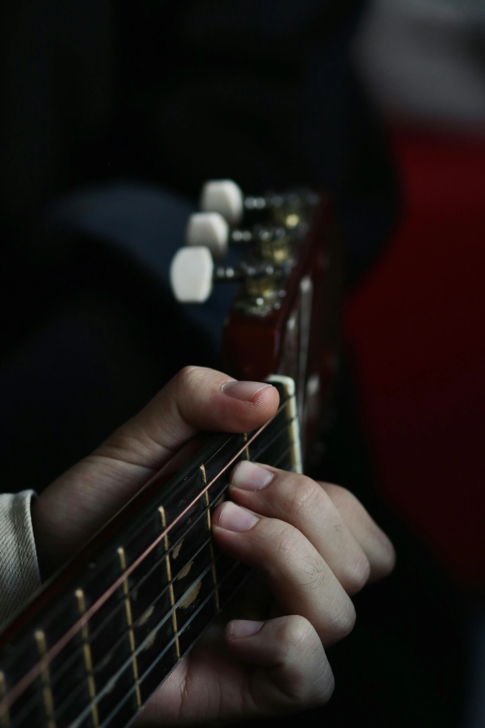 a person with their fingers on an electric guitar