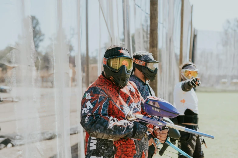 some people wearing skis standing in the grass