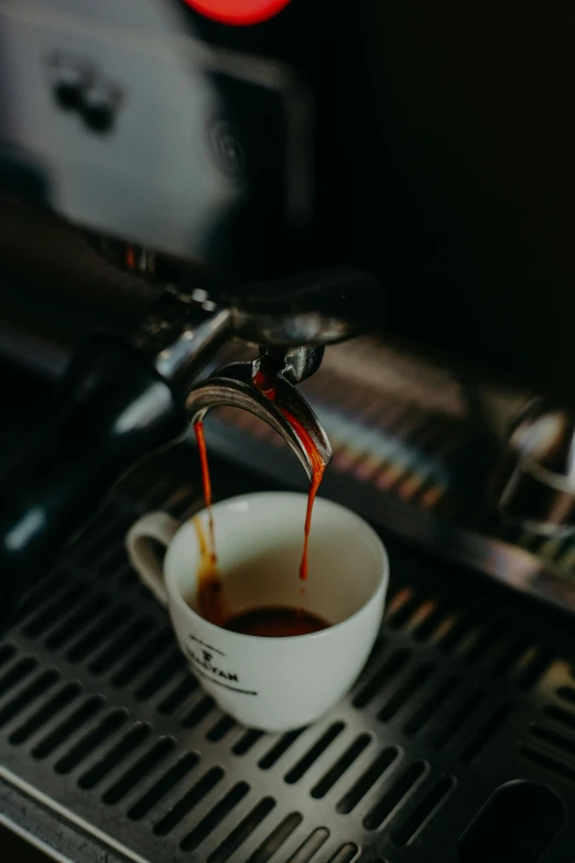 a cup filled with liquid coming out of it