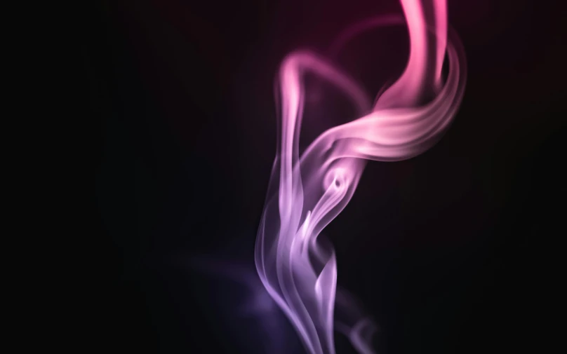 a purple smoke swirls in the air against a black background