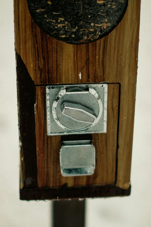 a close up view of a device attached to a wooden surface