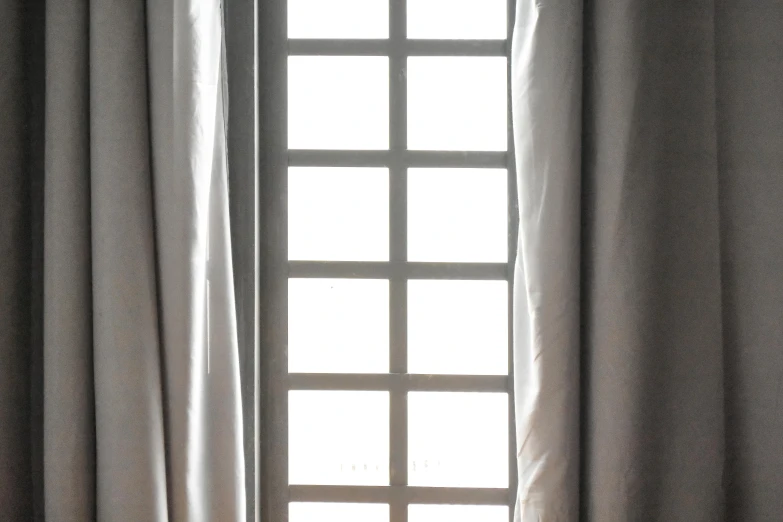 a window with curtains and the view through it