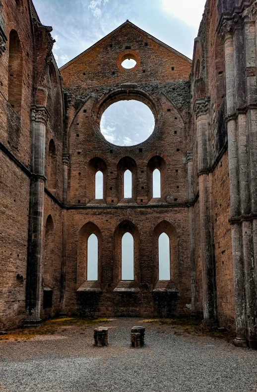 an abandoned church that is being refurbished and has two large arched windows