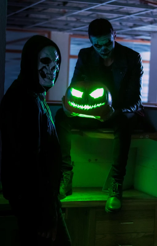 a couple of people sitting around a small table in the dark