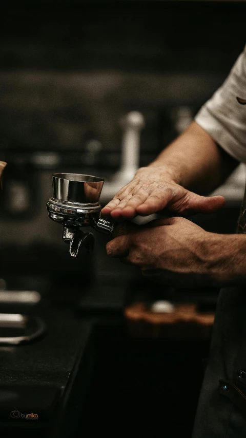 a person putting a coffee mug in to a cup