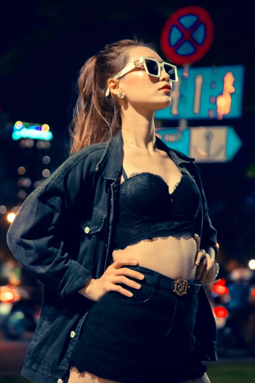 a woman in sunglasses standing on the street