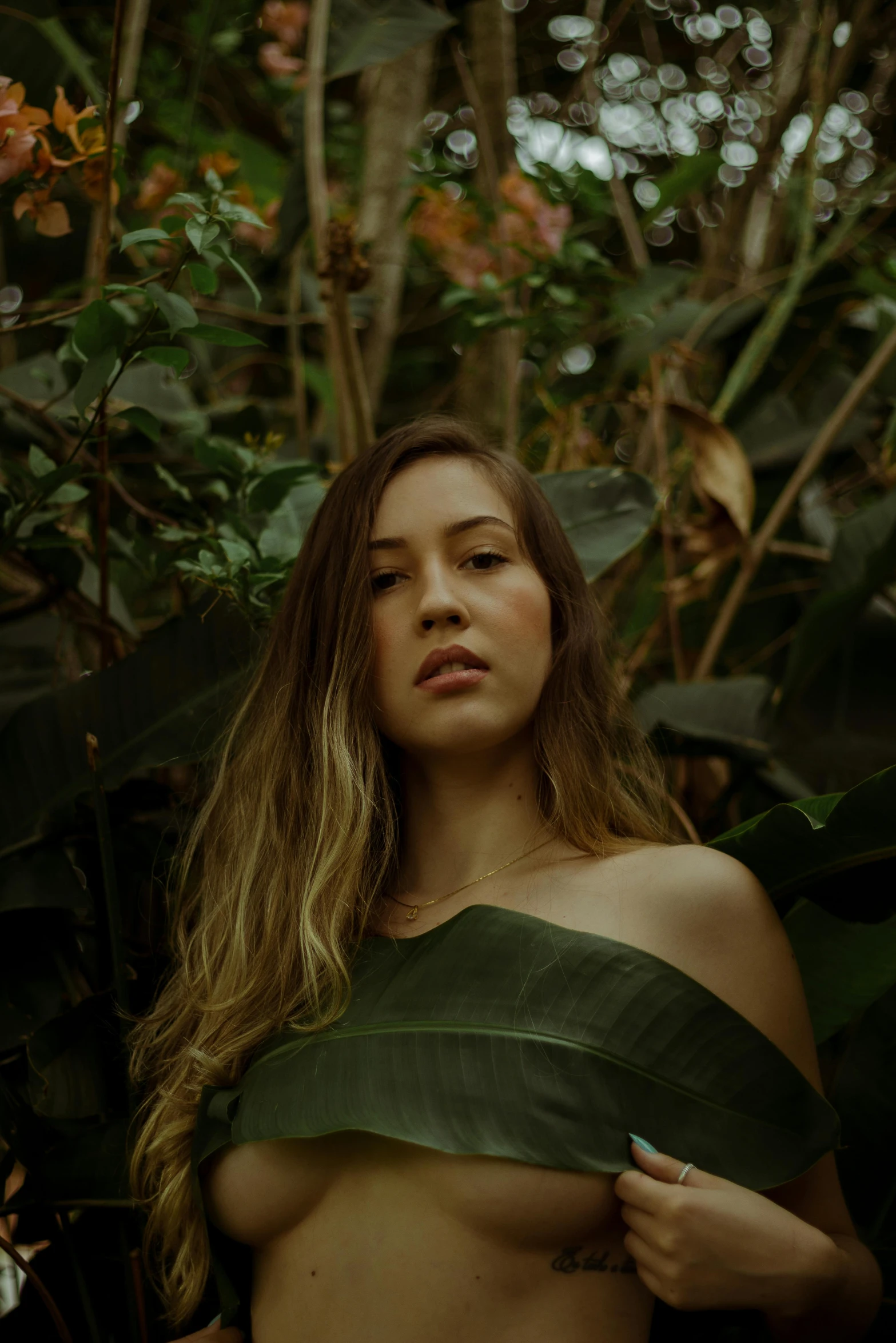 a young beautiful woman posing in the jungle