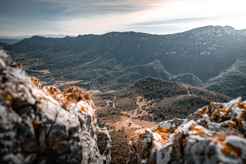 the view from a mountain with yellow and orange grass