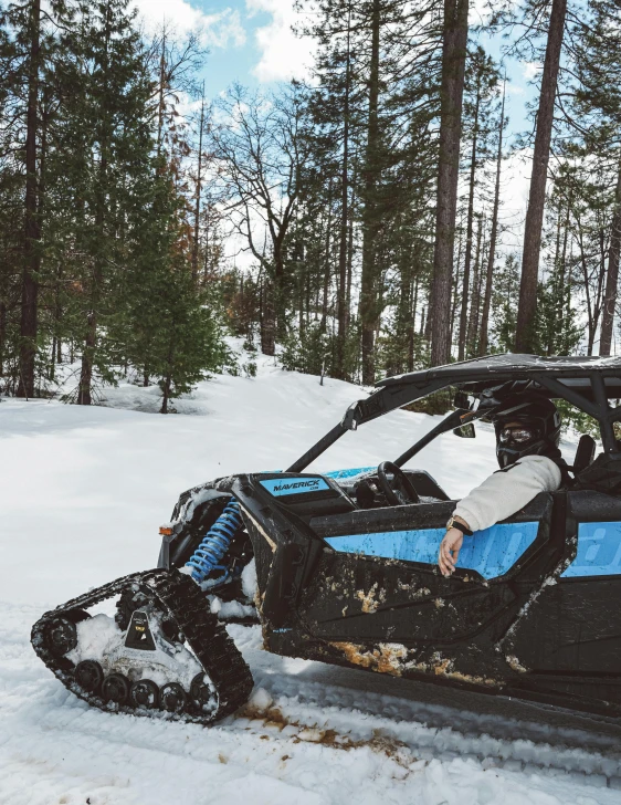 a snowmobile on the ground next to trees