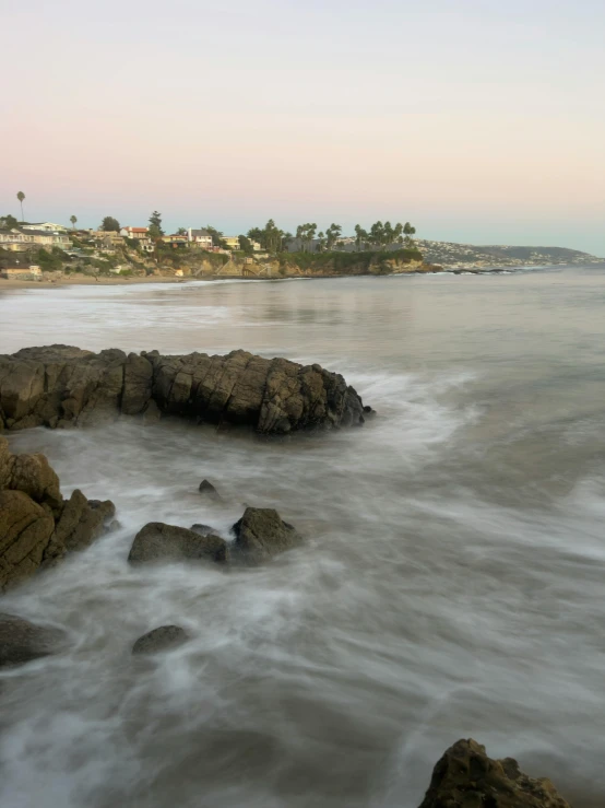 the sea is rolling in and around the shore