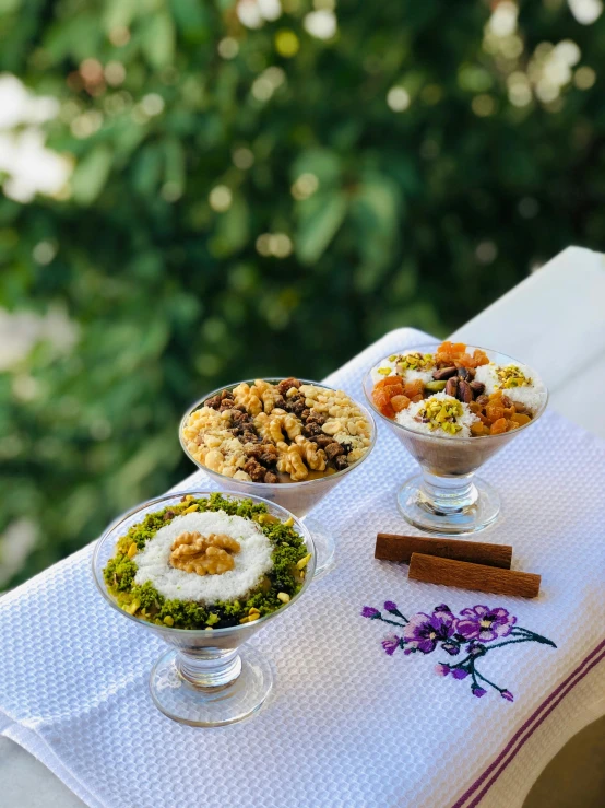 a close up of three different dishes of food on a table