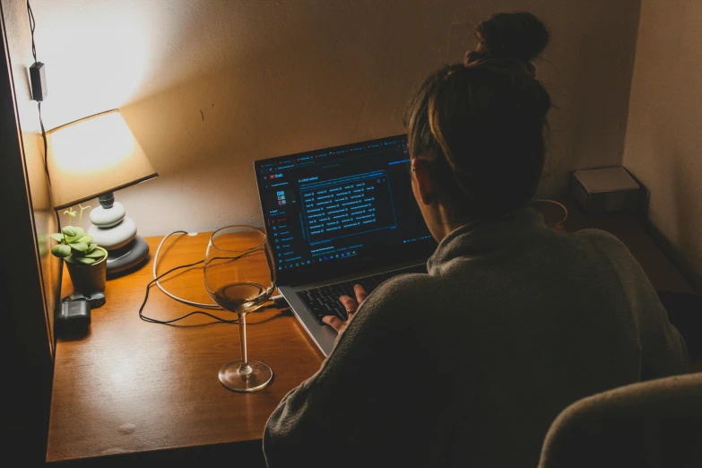 a woman at a desk on a laptop computer