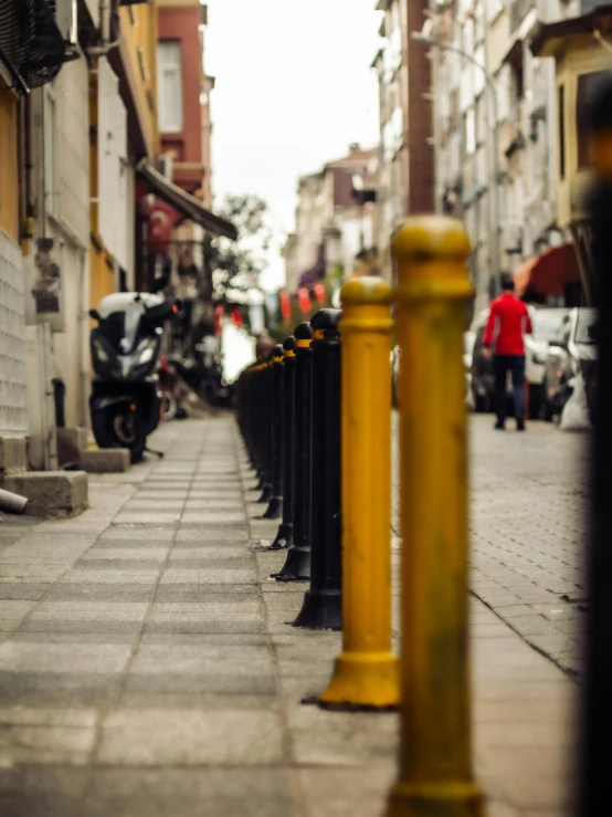 an image of a city street with a line of cars and people