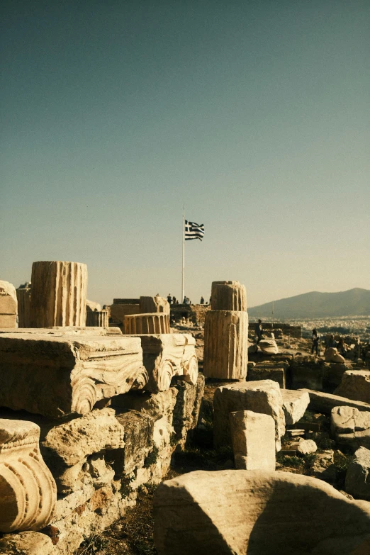 an image of antique ruins with a flag on it