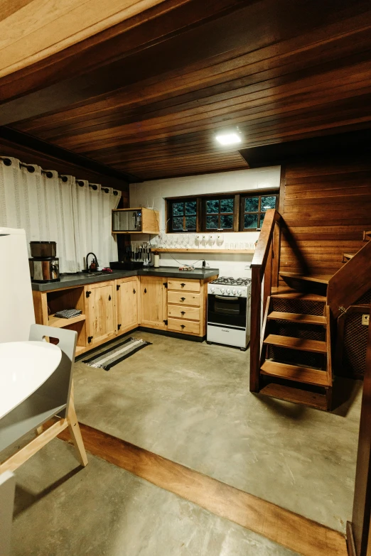 a kitchen with wood paneled walls and countertops